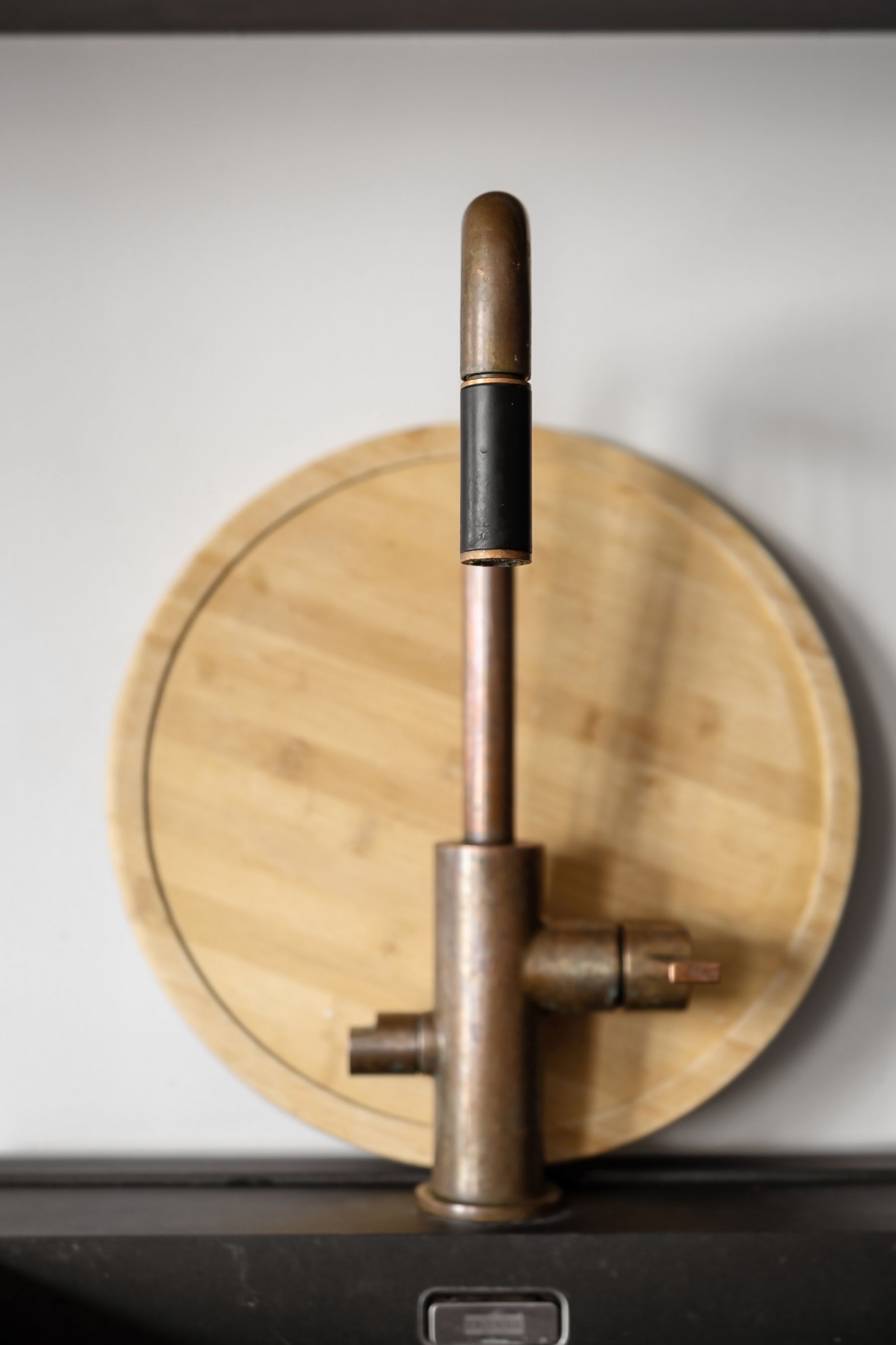 Close example of a brass tap base, lever and fixture connection