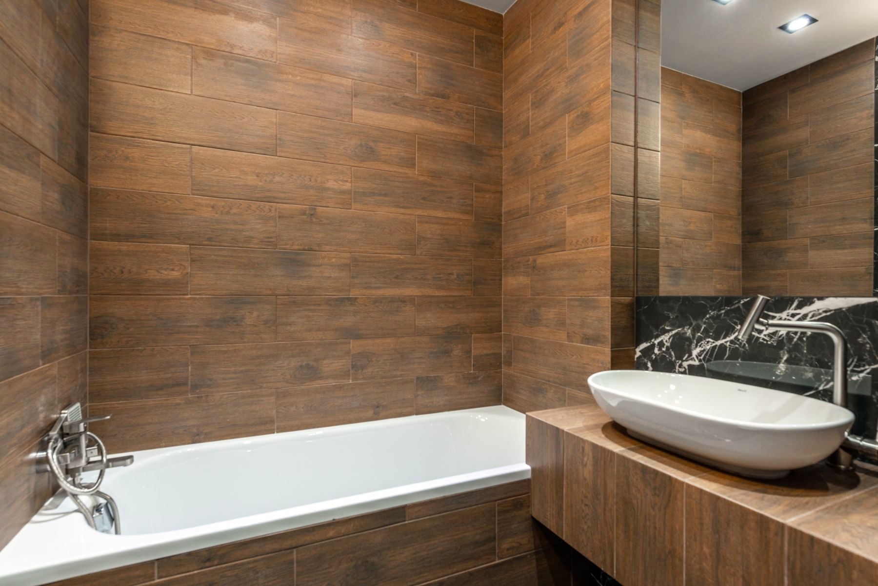 Finished bathroom with bath, mixer and basin — illustrative fixture context