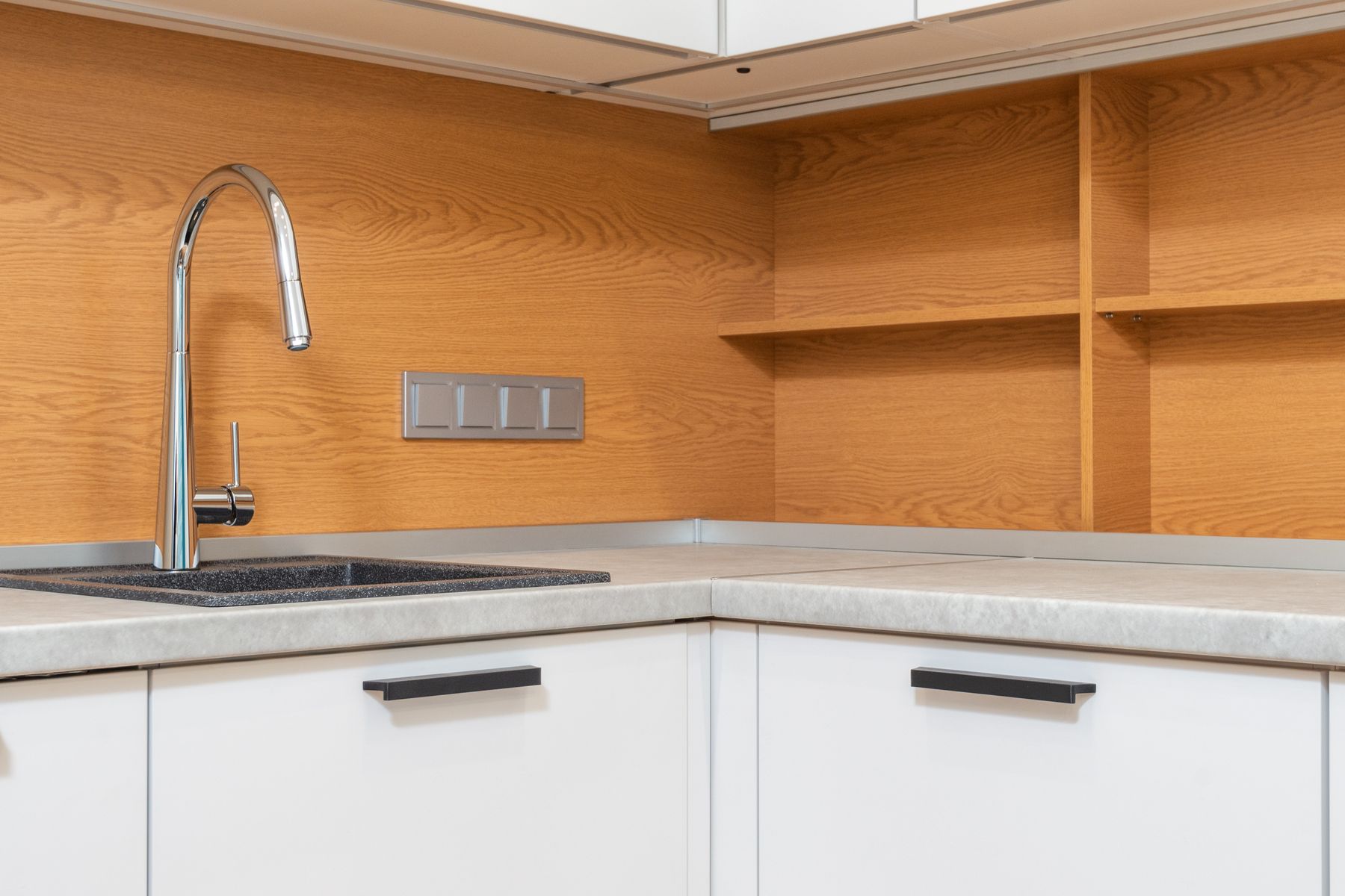 Kitchen sink and mixer in their surrounding worktop, showing context around the fixture