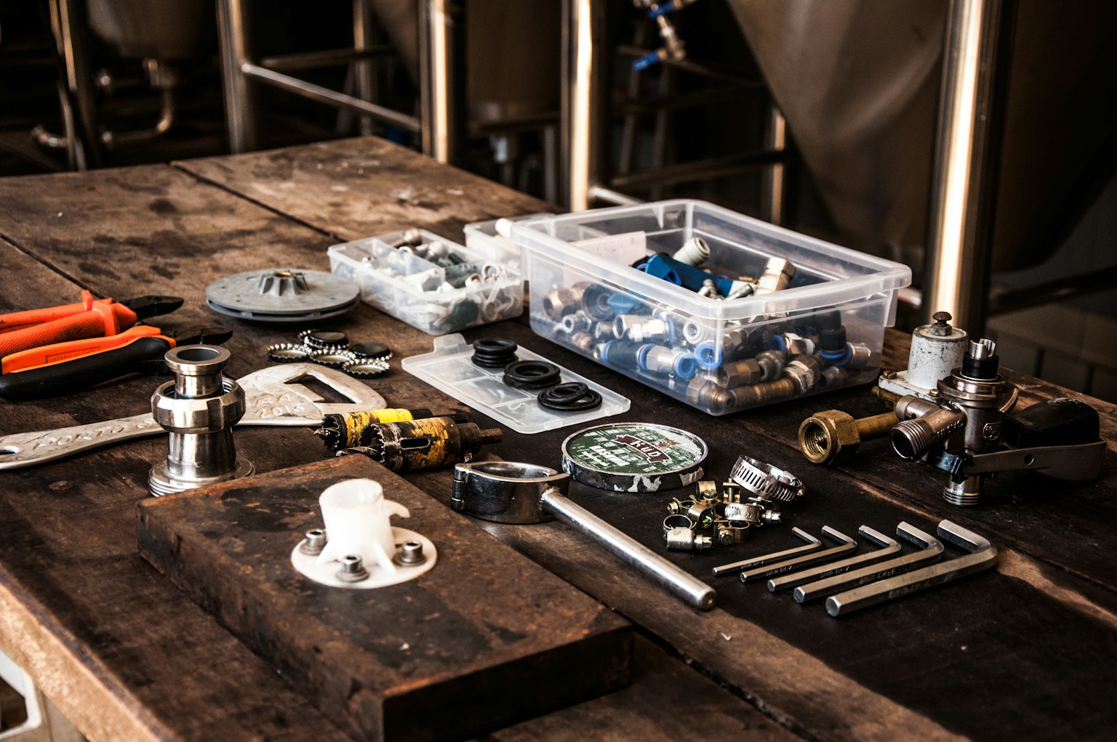 Tools and plumbing components on a workbench